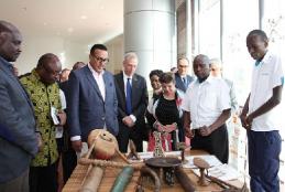 David Madanji (second right) of Iagas Material Culture Section shows guests some  items  that are part of the section's collection. 
