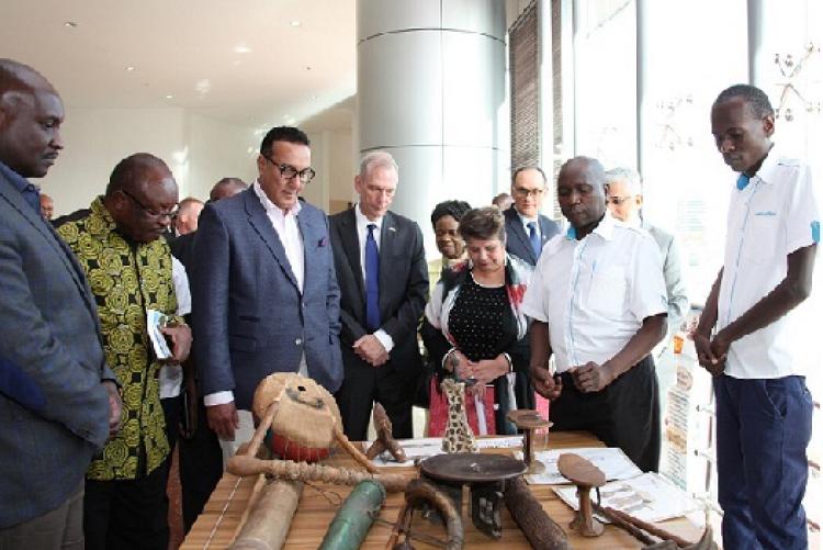 David Madanji (second right) of Iagas Material Culture Section shows guests some  items  that are part of the section's collection. 