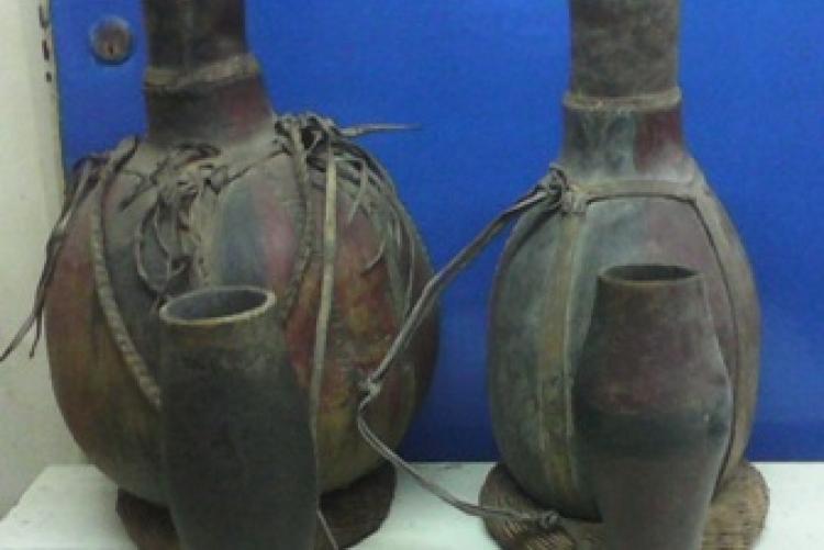  Turkana milk gourds with top covers at the front